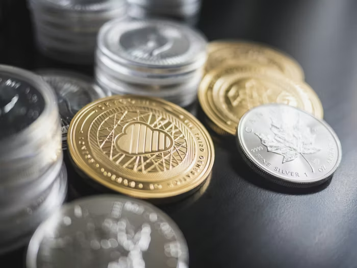 A collection of gold and silver coins on a table