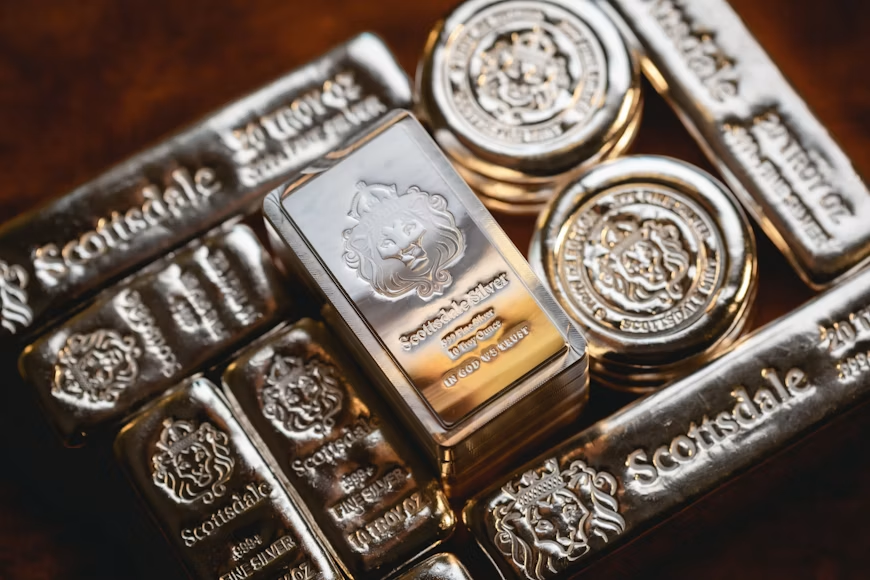A bunch of silver bars and coins stacked on top of each other