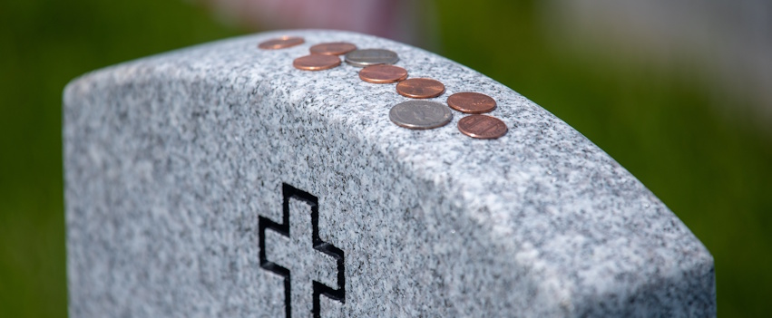 coins on gravestone