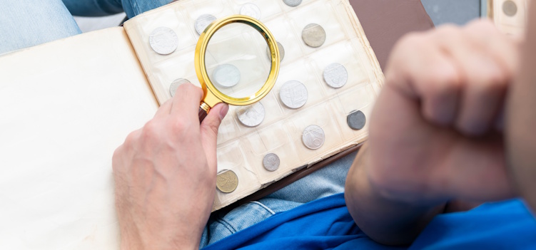 a coin collector looking at his collection