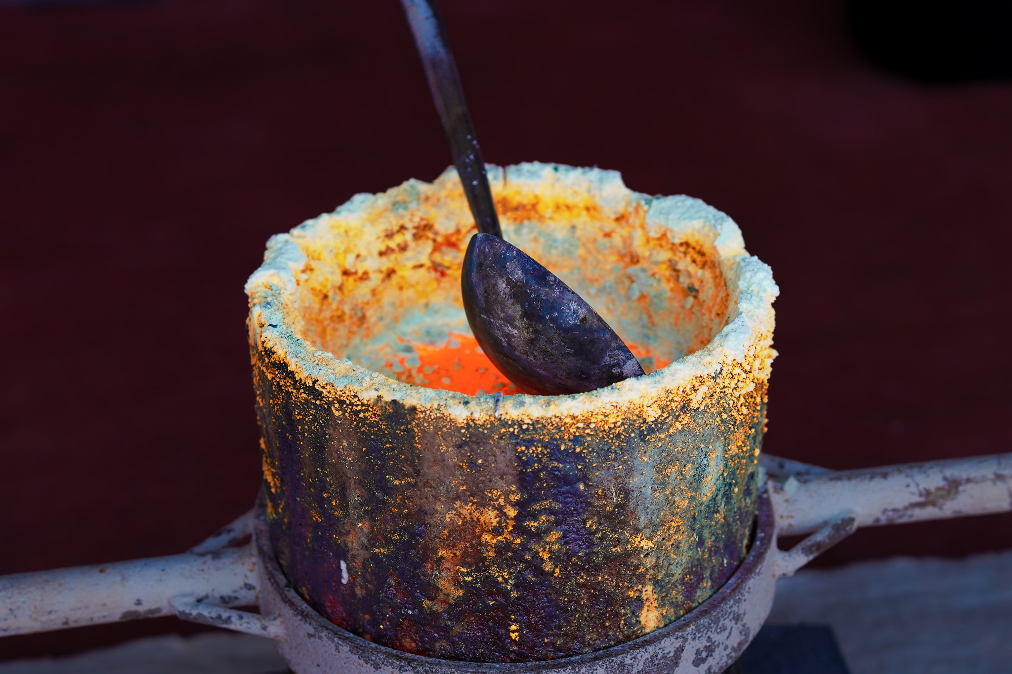 A well used mortar with molten material and chemical buildup from the refining process.