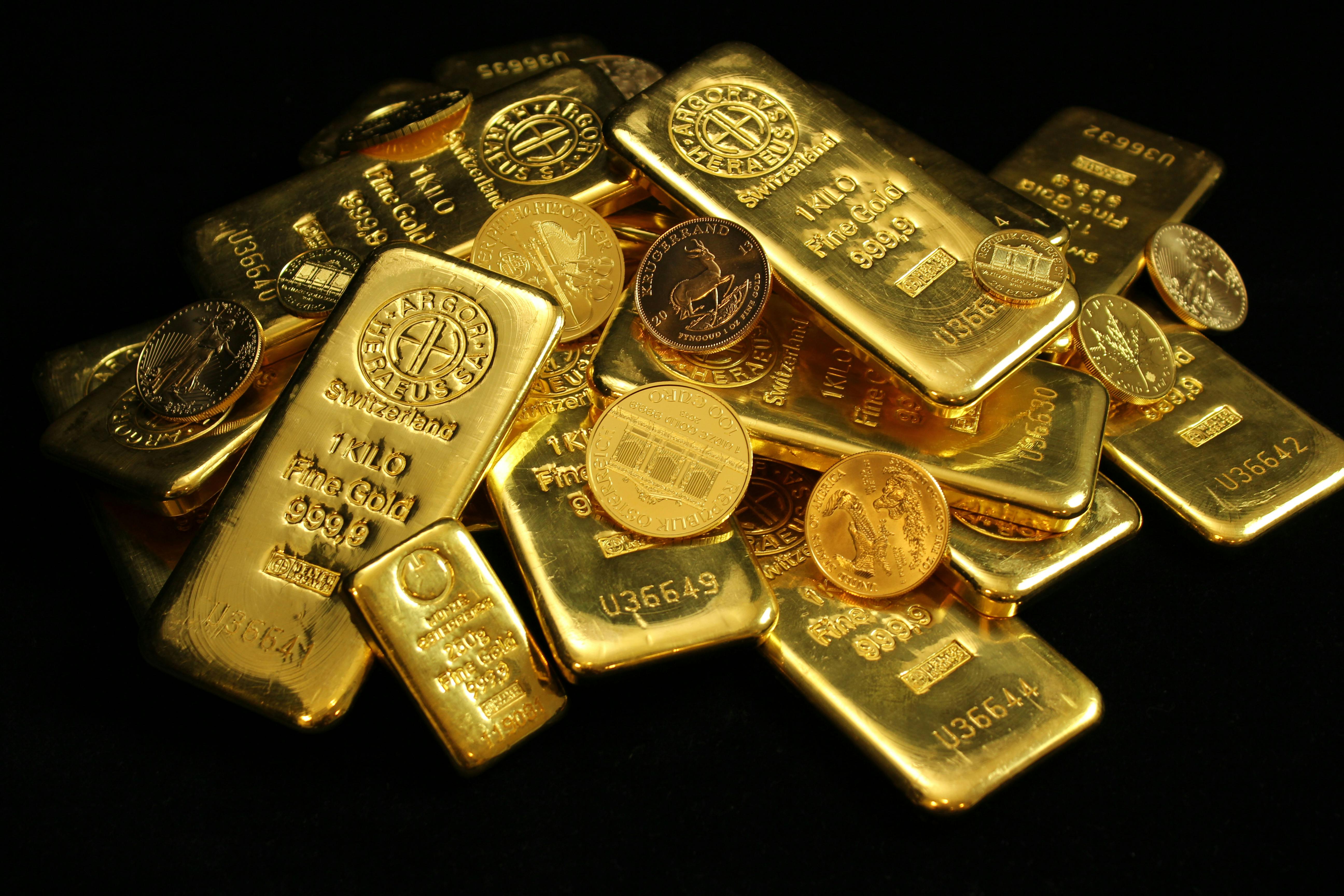 gold bars and coins in a pile